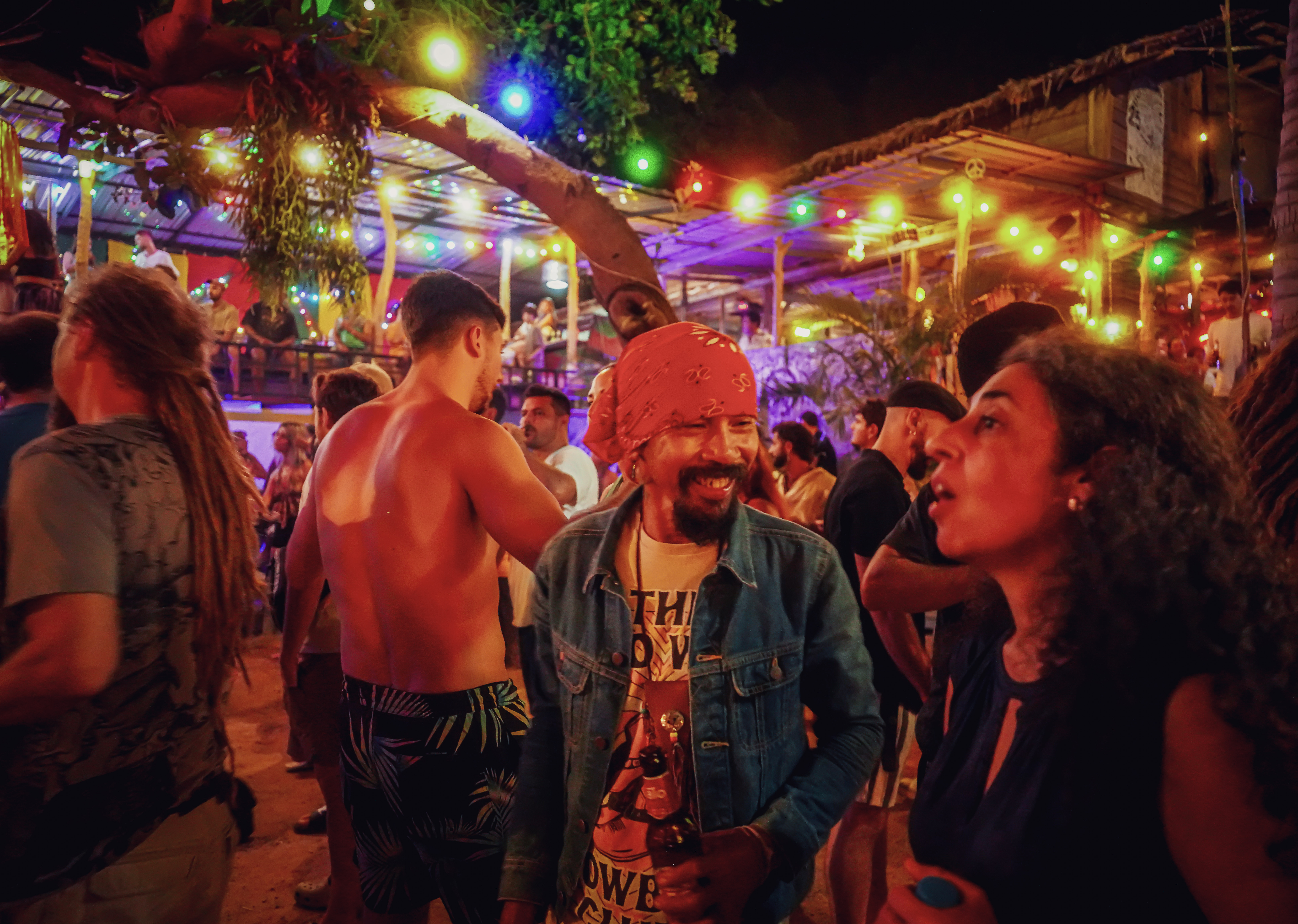 Guest enjoying the night under colorful stage lights.