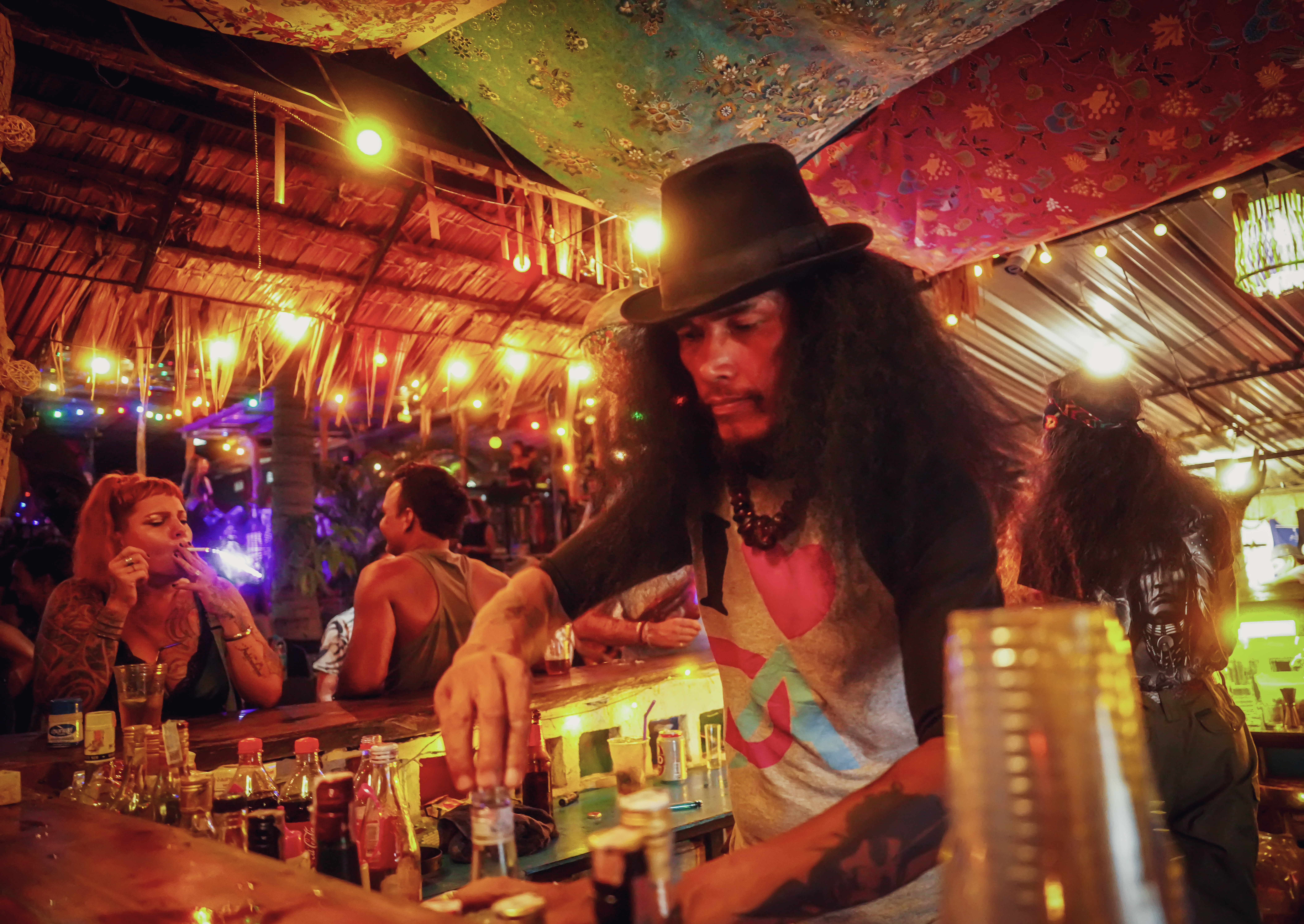 Bartender preparing drinks at the ground-level bar.