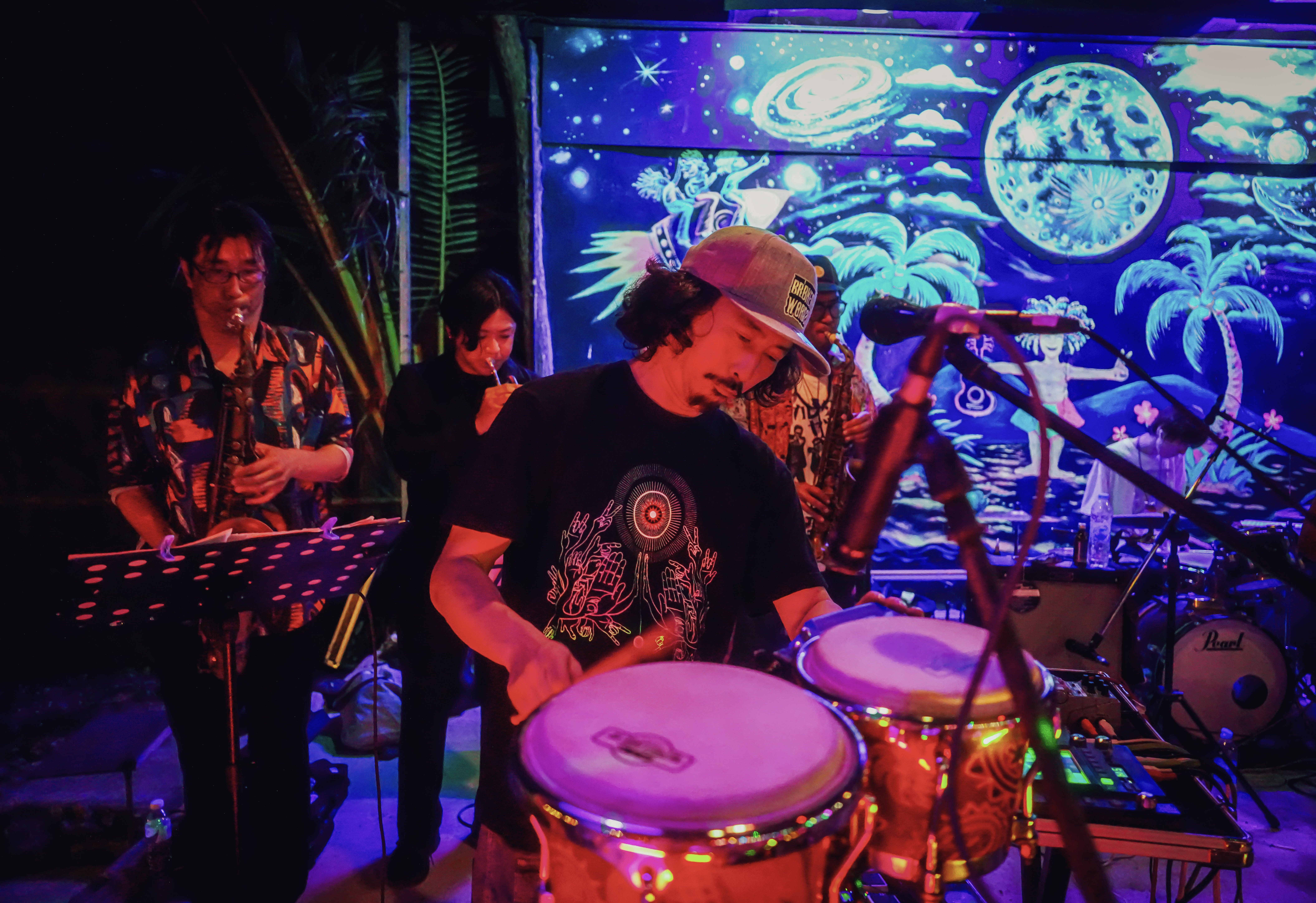 Band playing live with full moon in the background.
