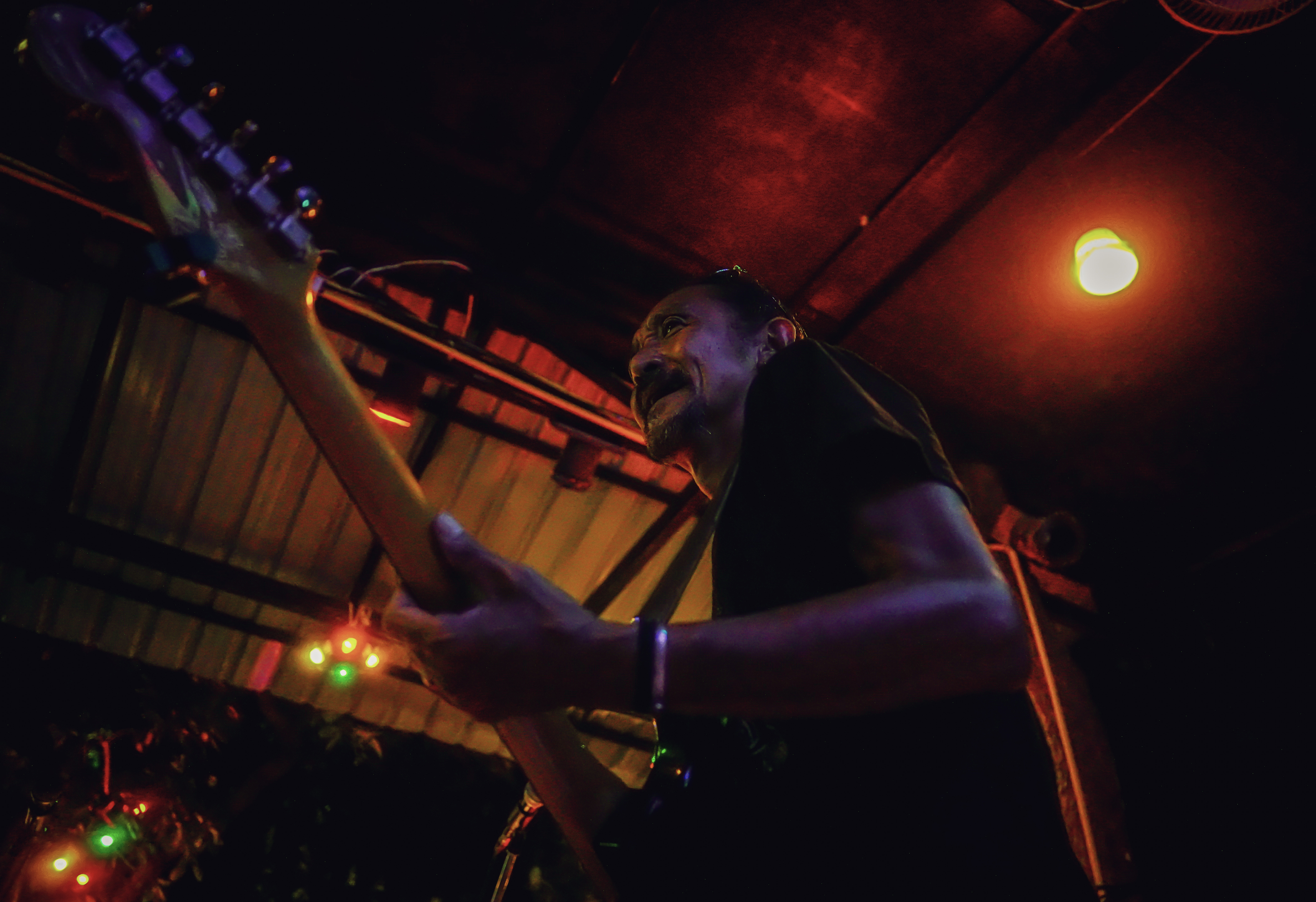 Guitarist playing live under beautiful lighting.