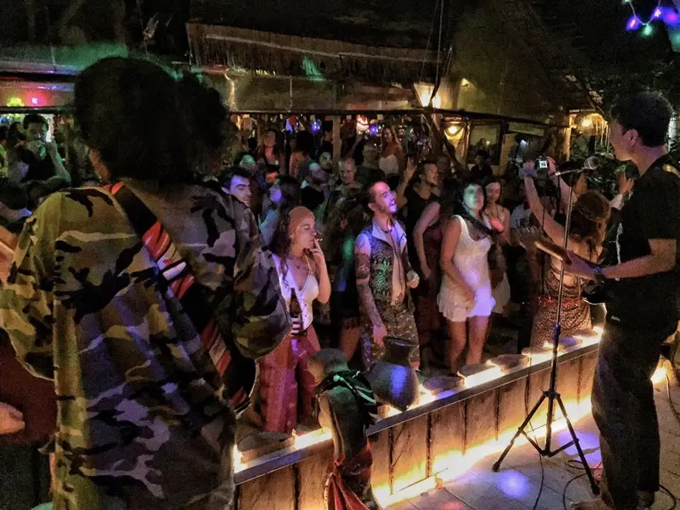Stage view with colorful lights and guest enjoying the night at Rasta Home.