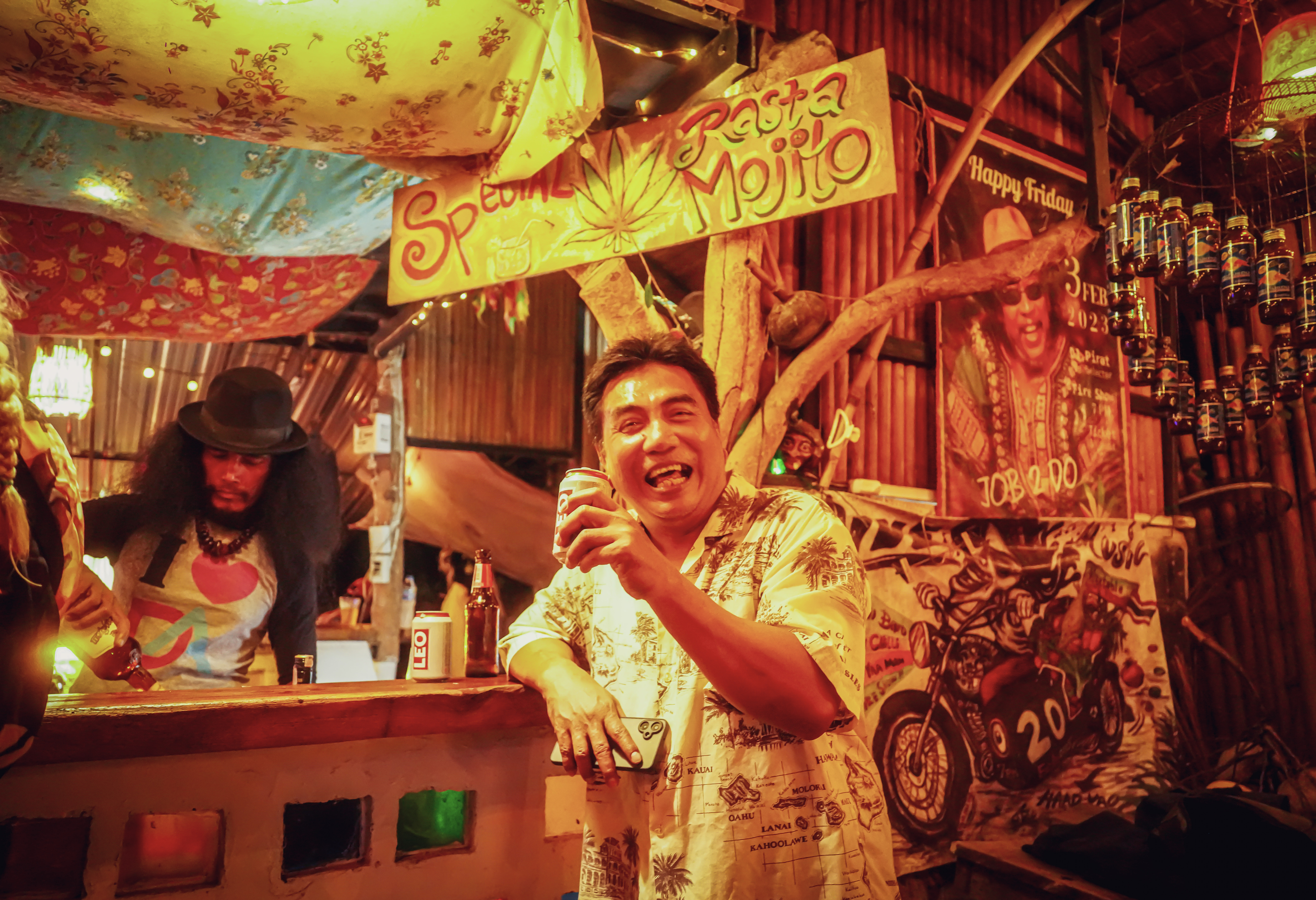 Guest drinking leo beer at the bar in Rasta Home