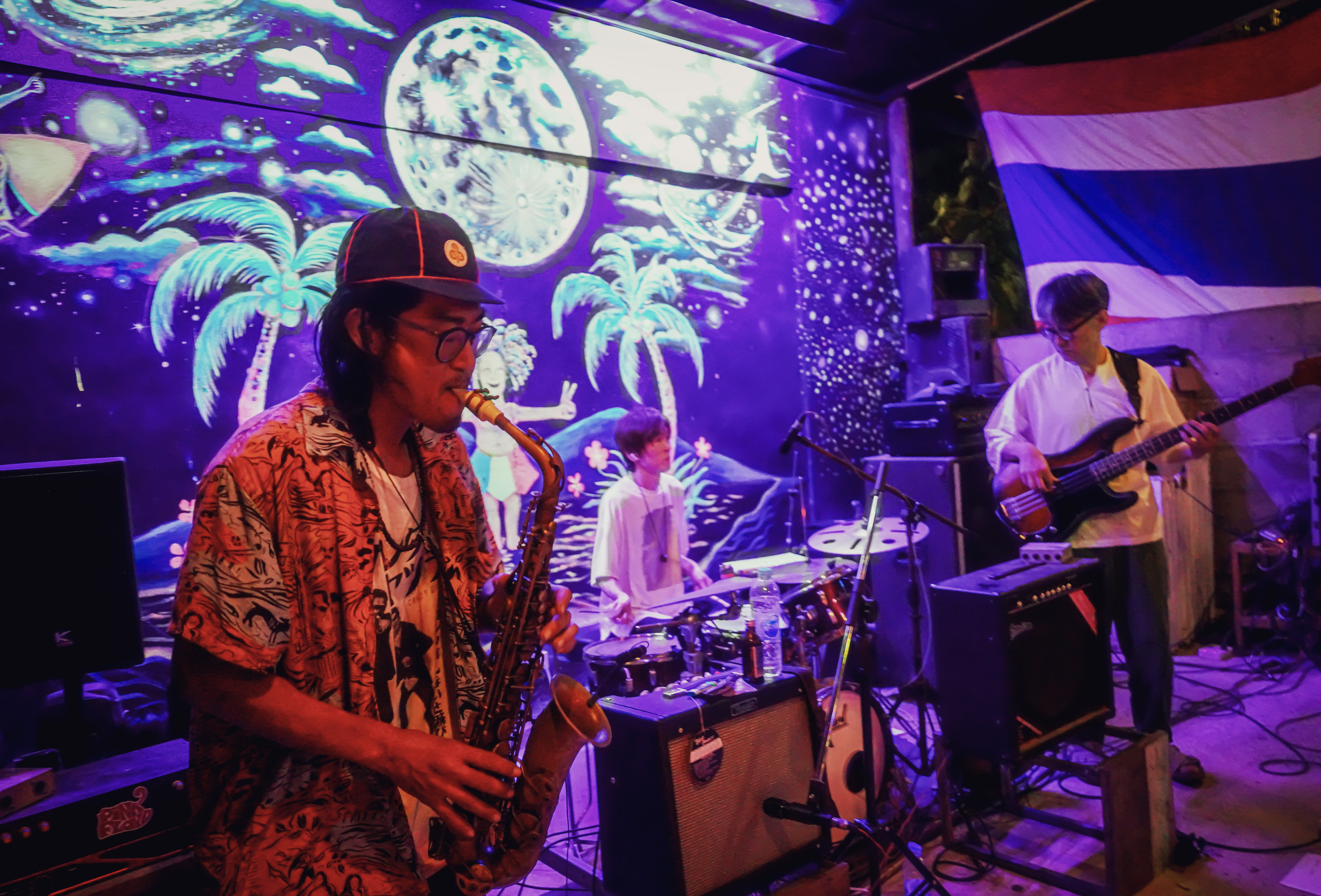 Saxophonist and guitarist performing live on stage.