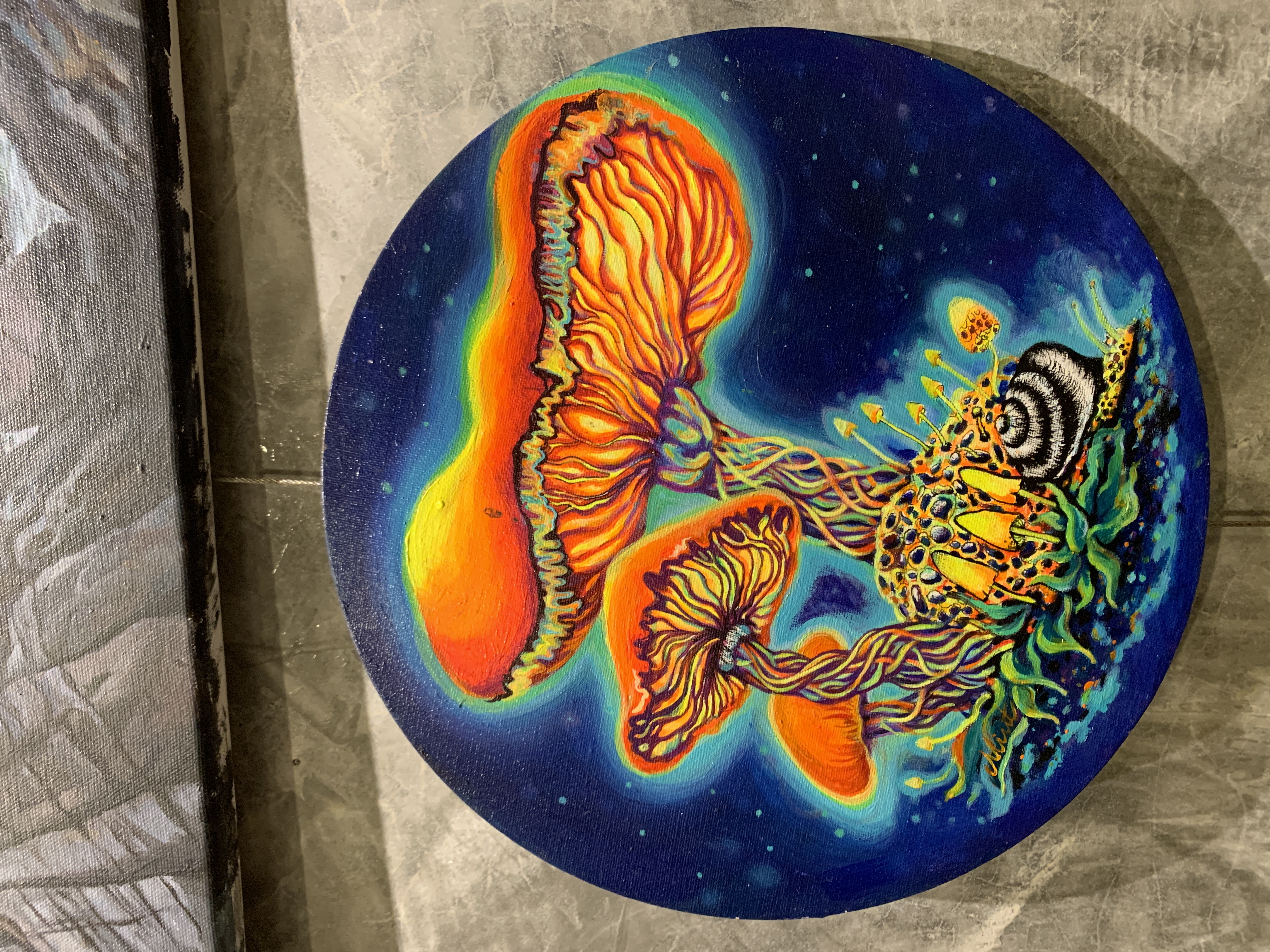 Psychedelic round painting of glowing mushrooms under a cosmic sky.