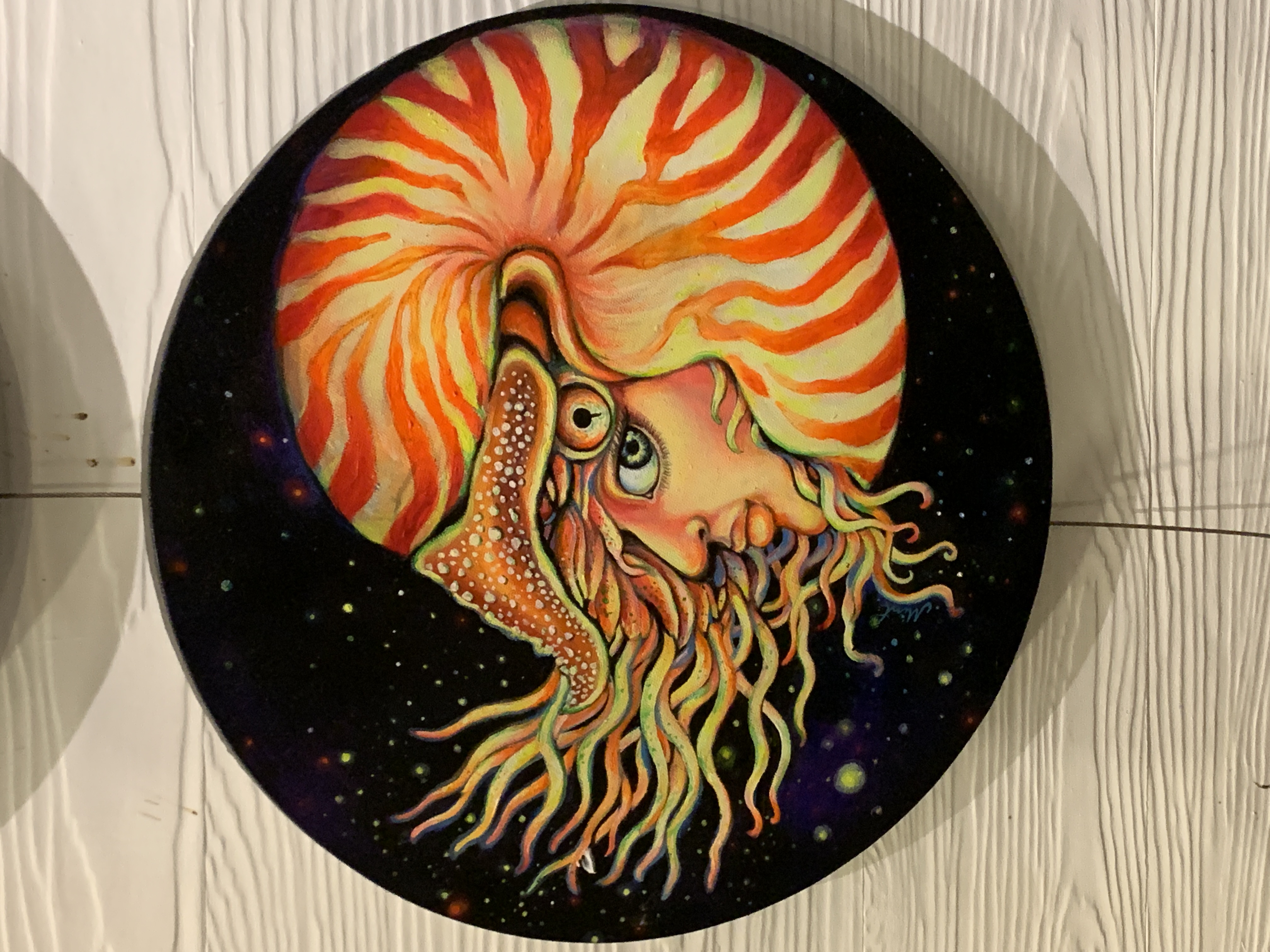 Cosmic round painting of a fiery sun spirit with flowing flames.